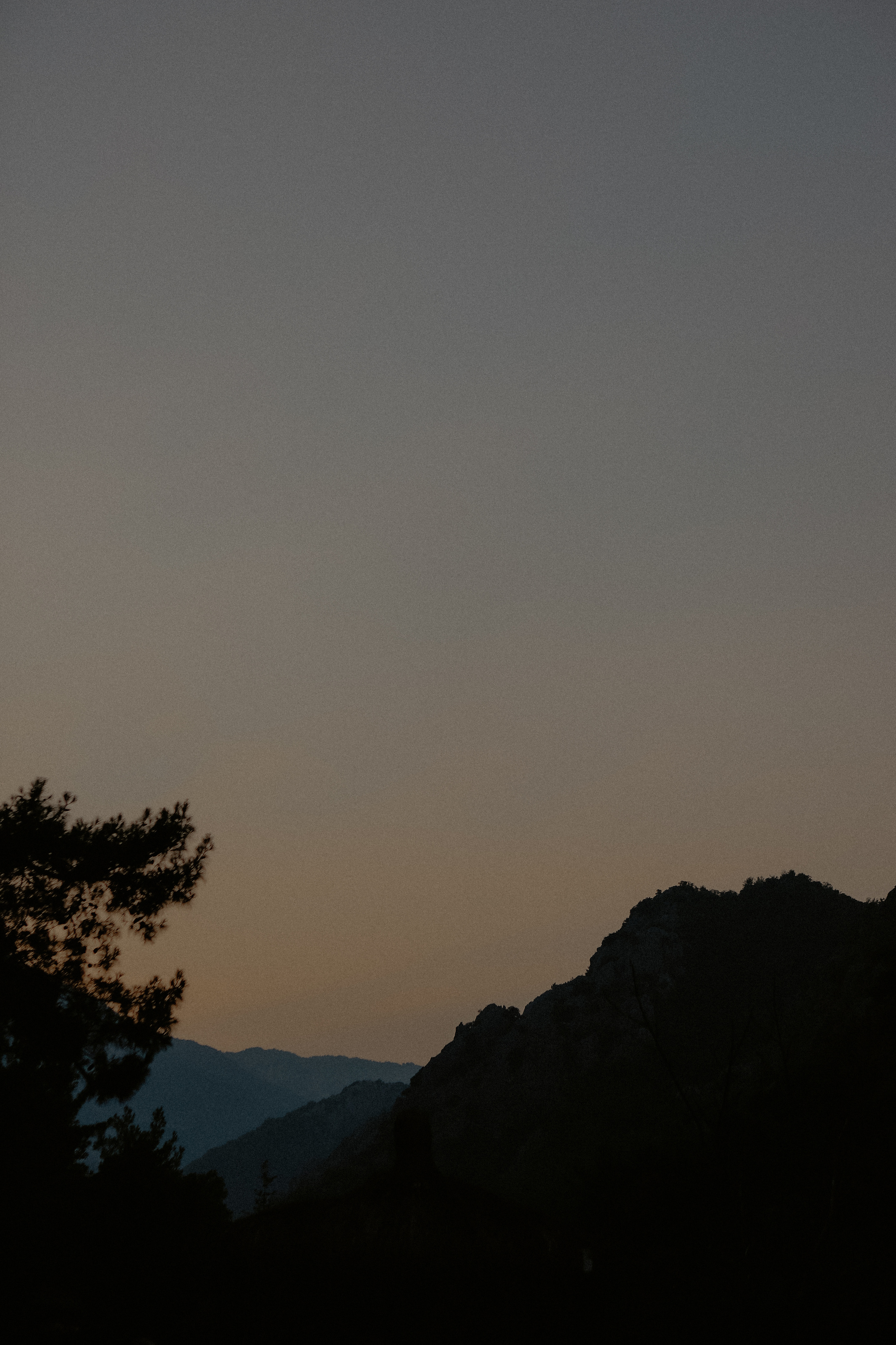 Distant mountains at dusk beneath an open sky