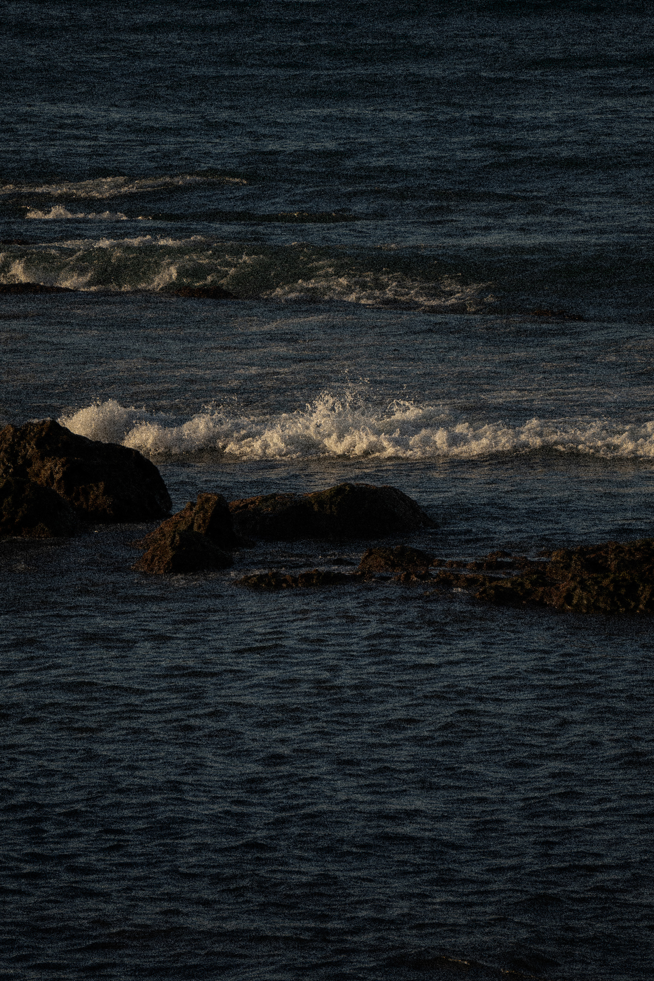 Waves moving over black rock