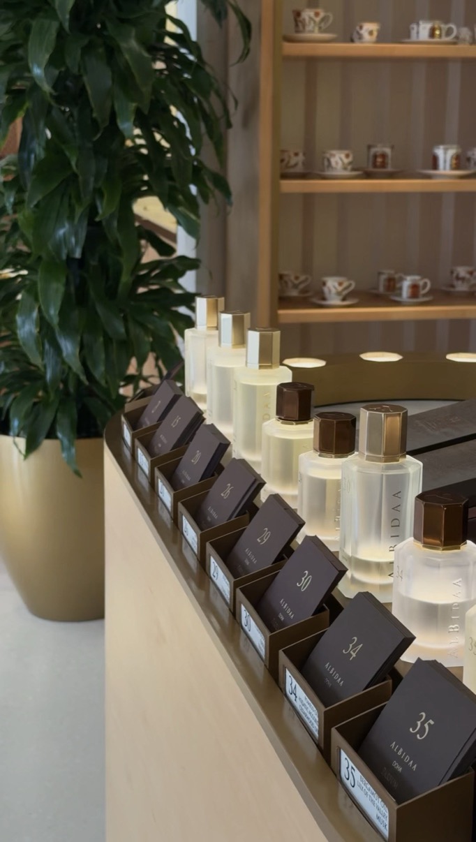 Perfume bottles and numbered sample boxes along a counter, Al Bidaa, Msheireb, Doha