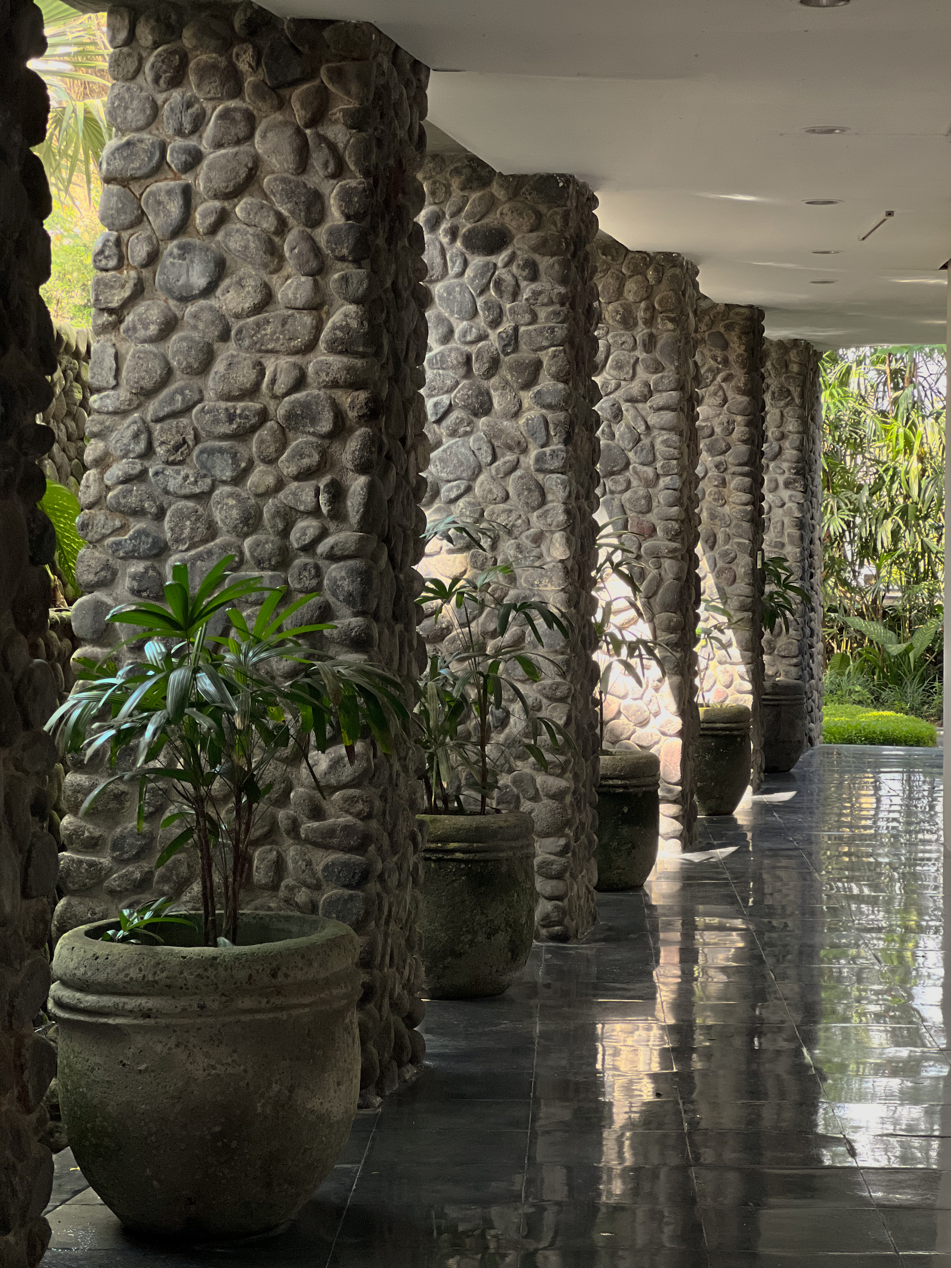 River stone columns and wet floor, Alila Ubud