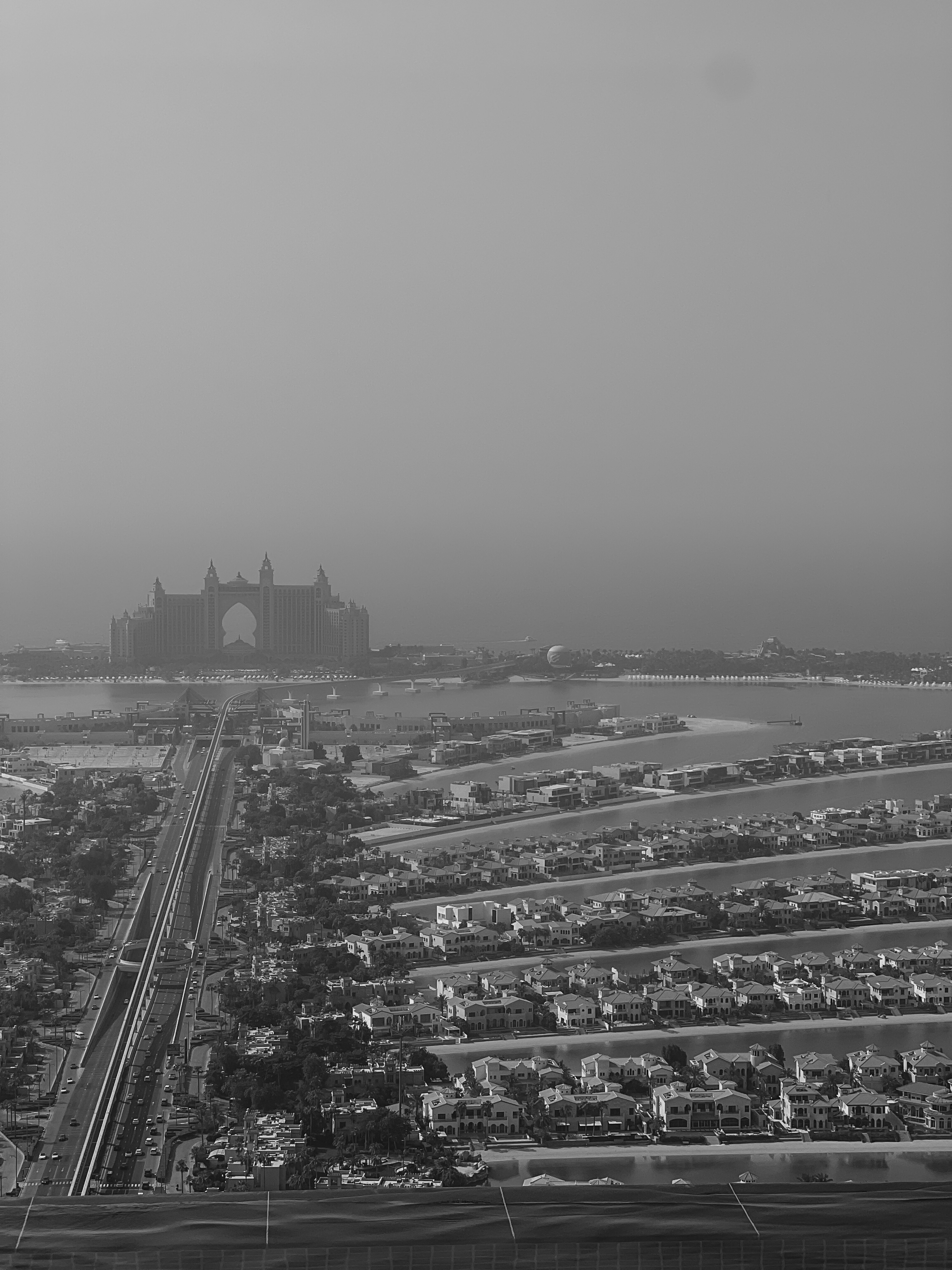 Atlantis and Palm Jumeirah in haze, black and white aerial view, Dubai