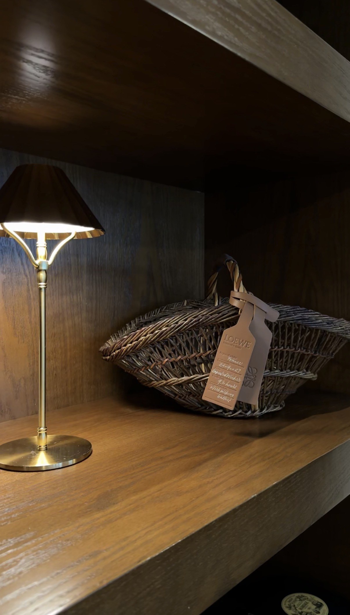 Basket and brass lamp on timber shelving, The Buttery Bakery, Doha