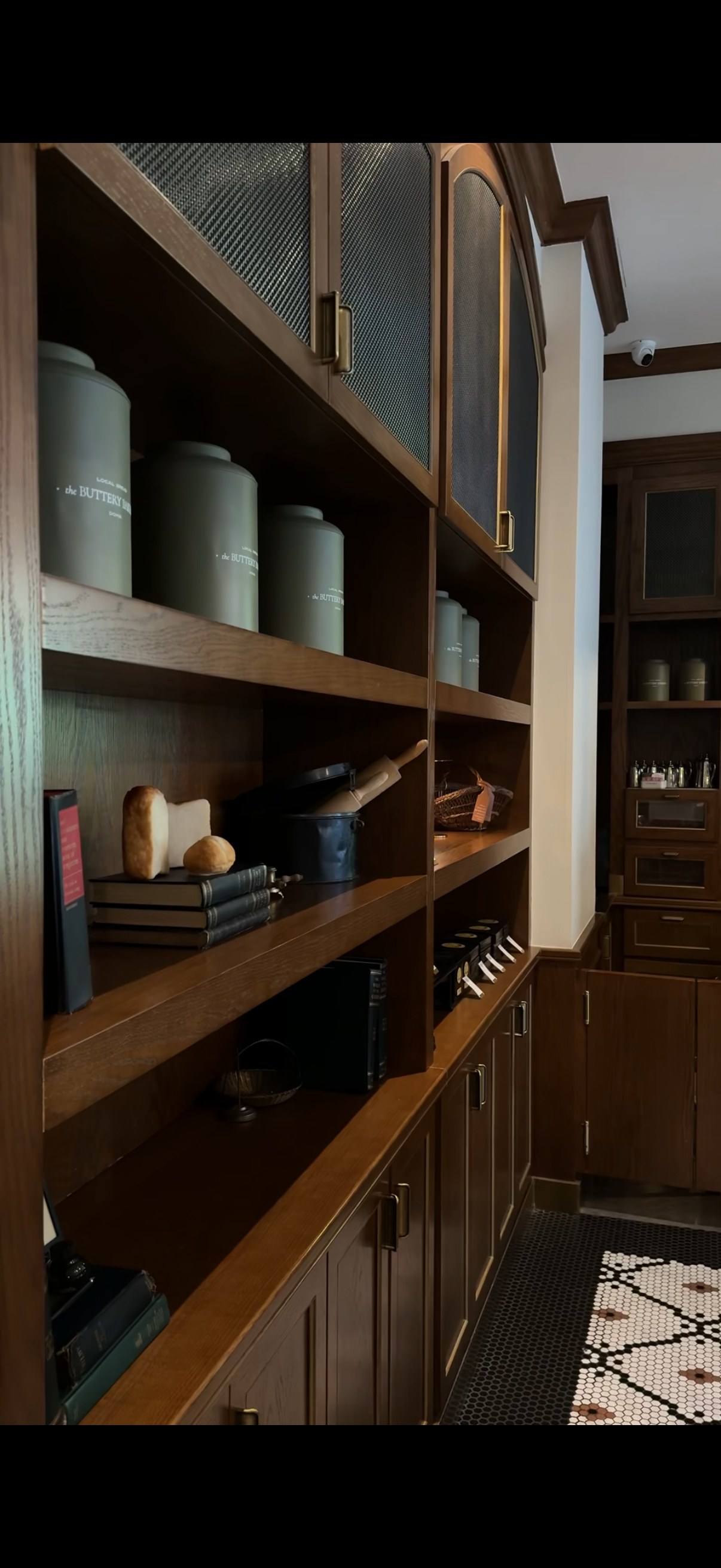 Timber shelving with books, camera and objects, The Buttery Bakery, Doha