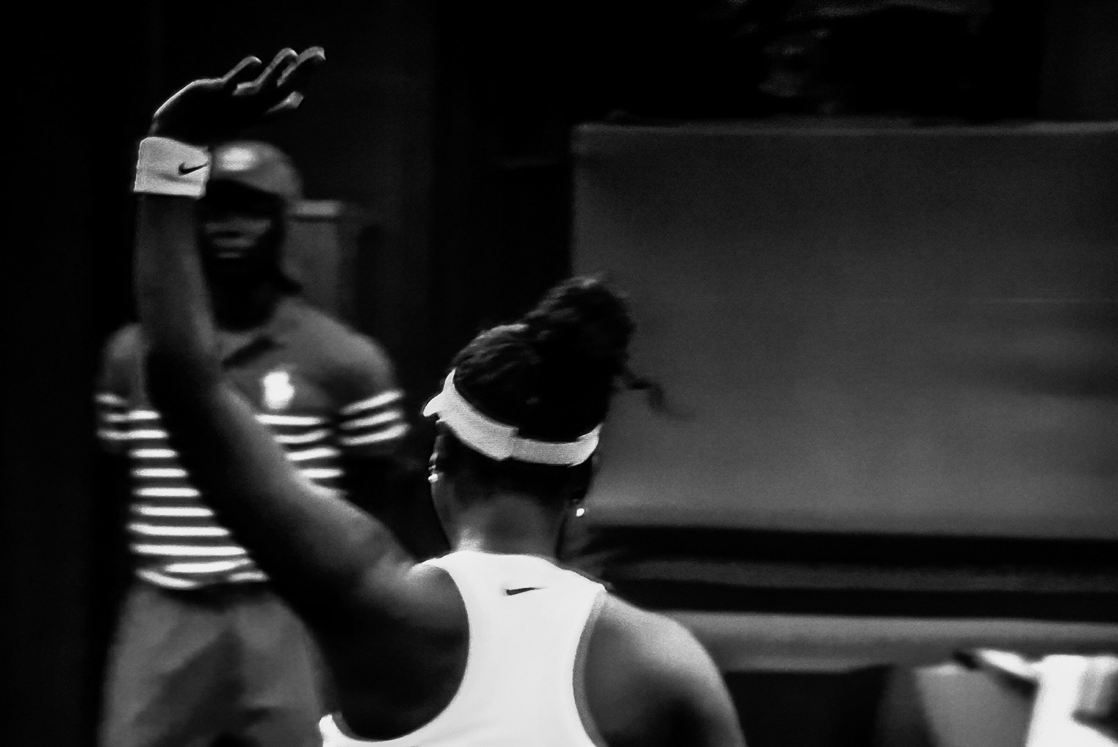A raised hand acknowledging the crowd, seen from behind