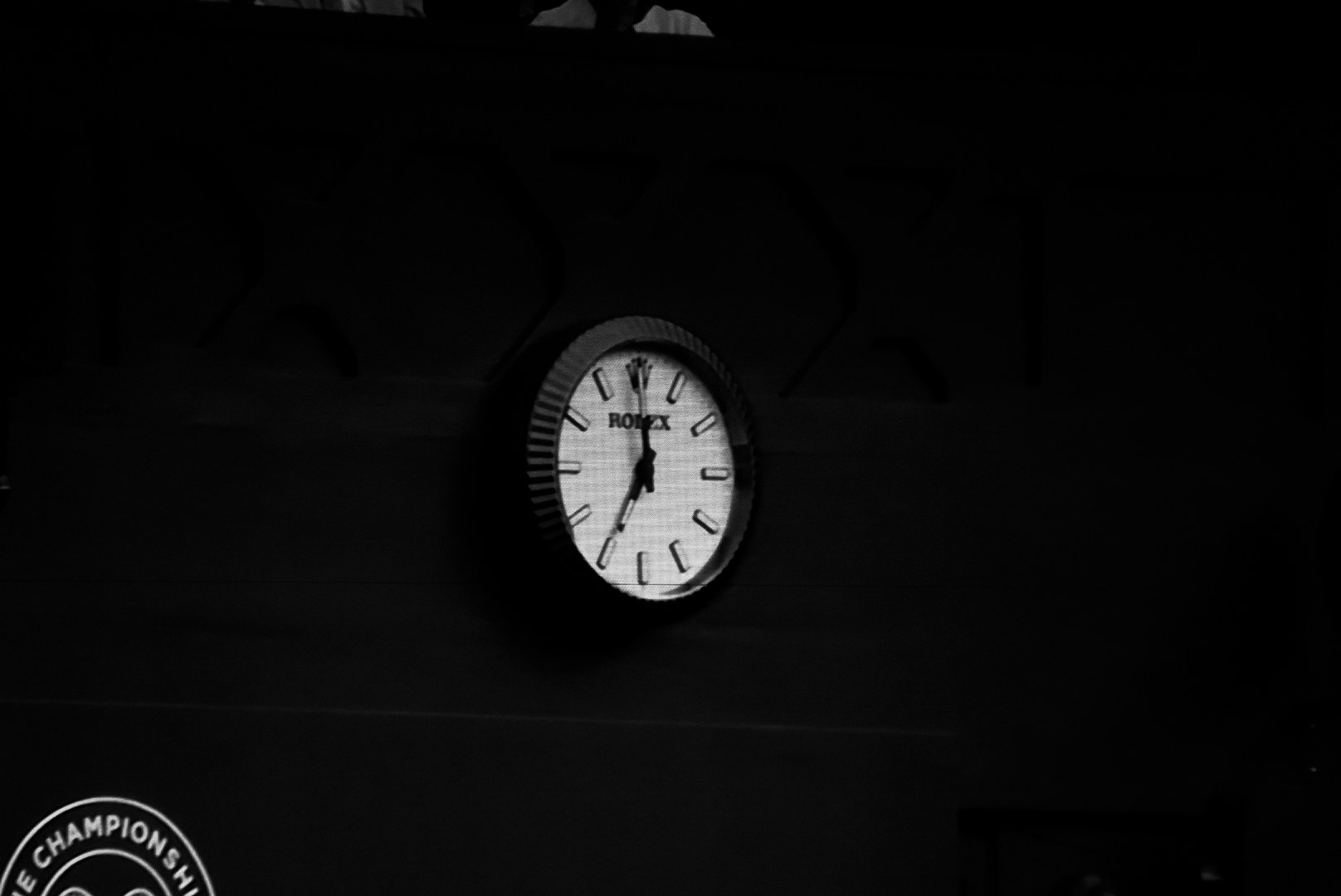 The clock on the dark wall of the court