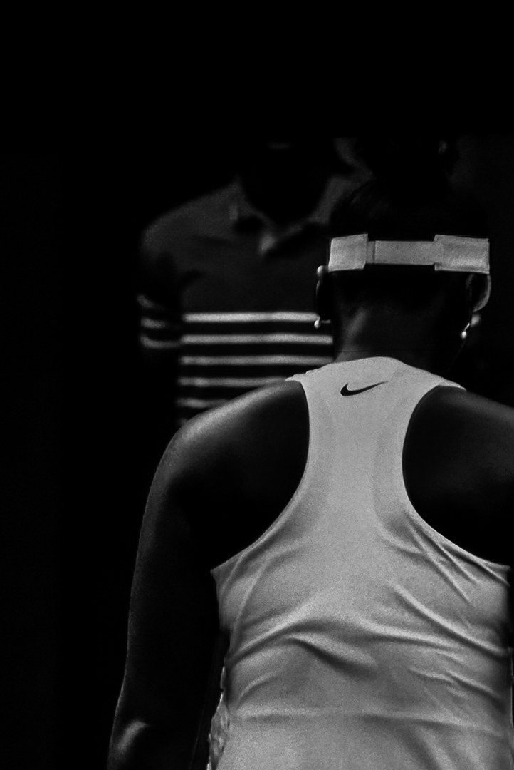 A player from behind, opponent out of focus beyond