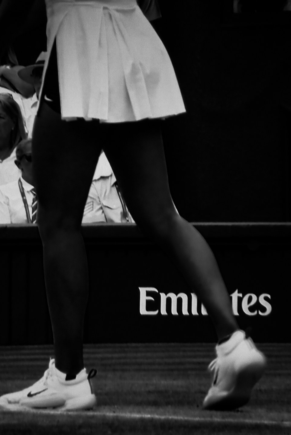 Legs at the edge of the court against the boards