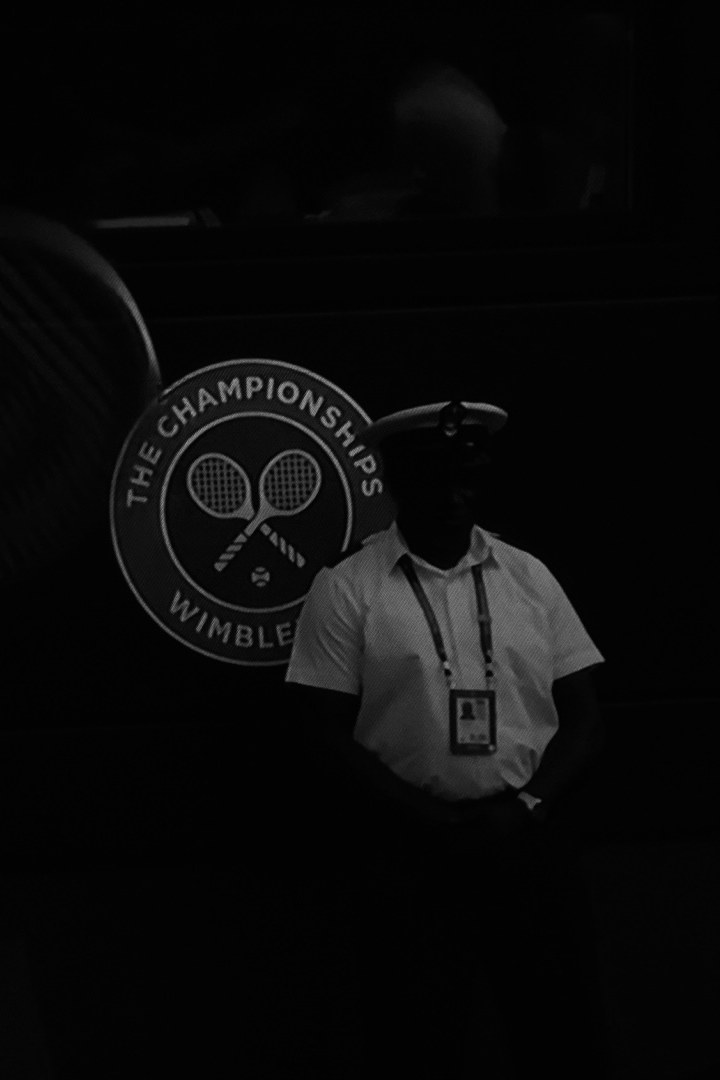 A steward standing in the dark beside the championship mark