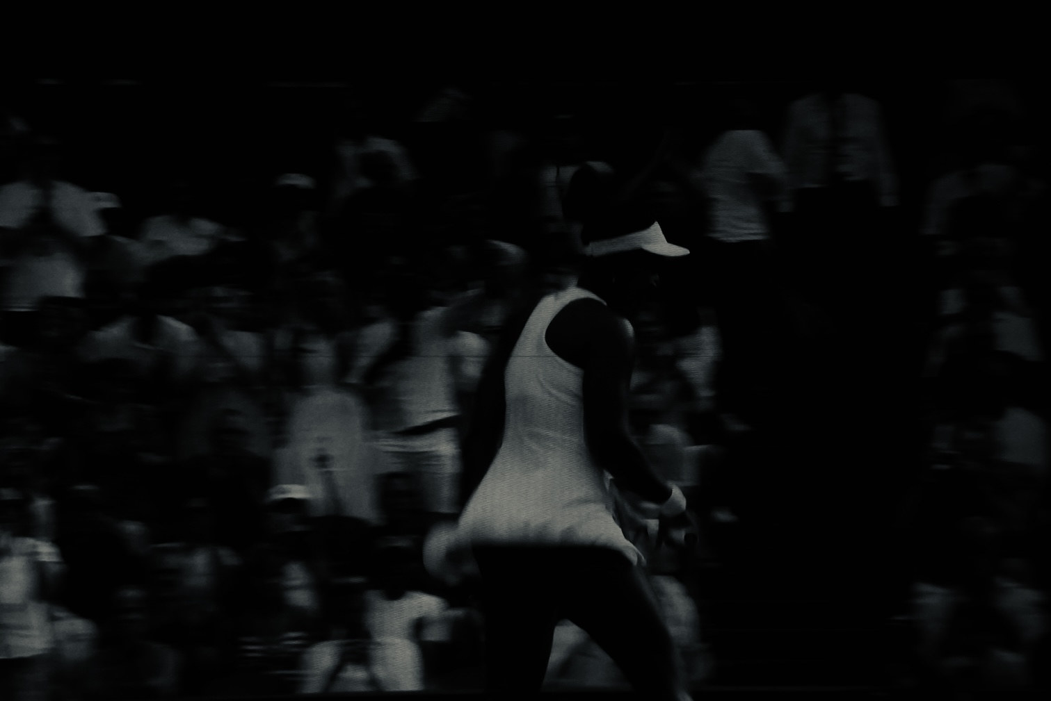 A player turning against the darkened crowd, motion blurred