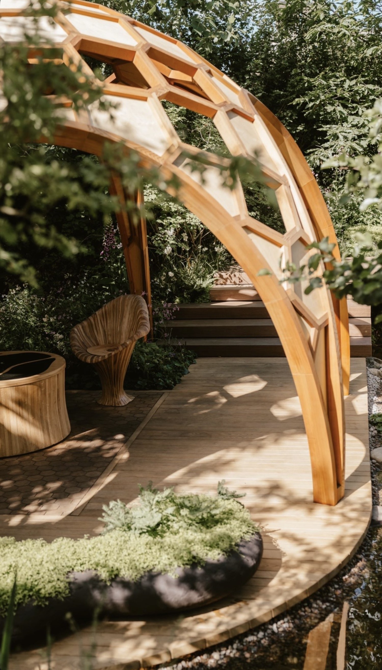 Water running from dark wall spouts into planting, RHS Chelsea Flower Show 2022, London