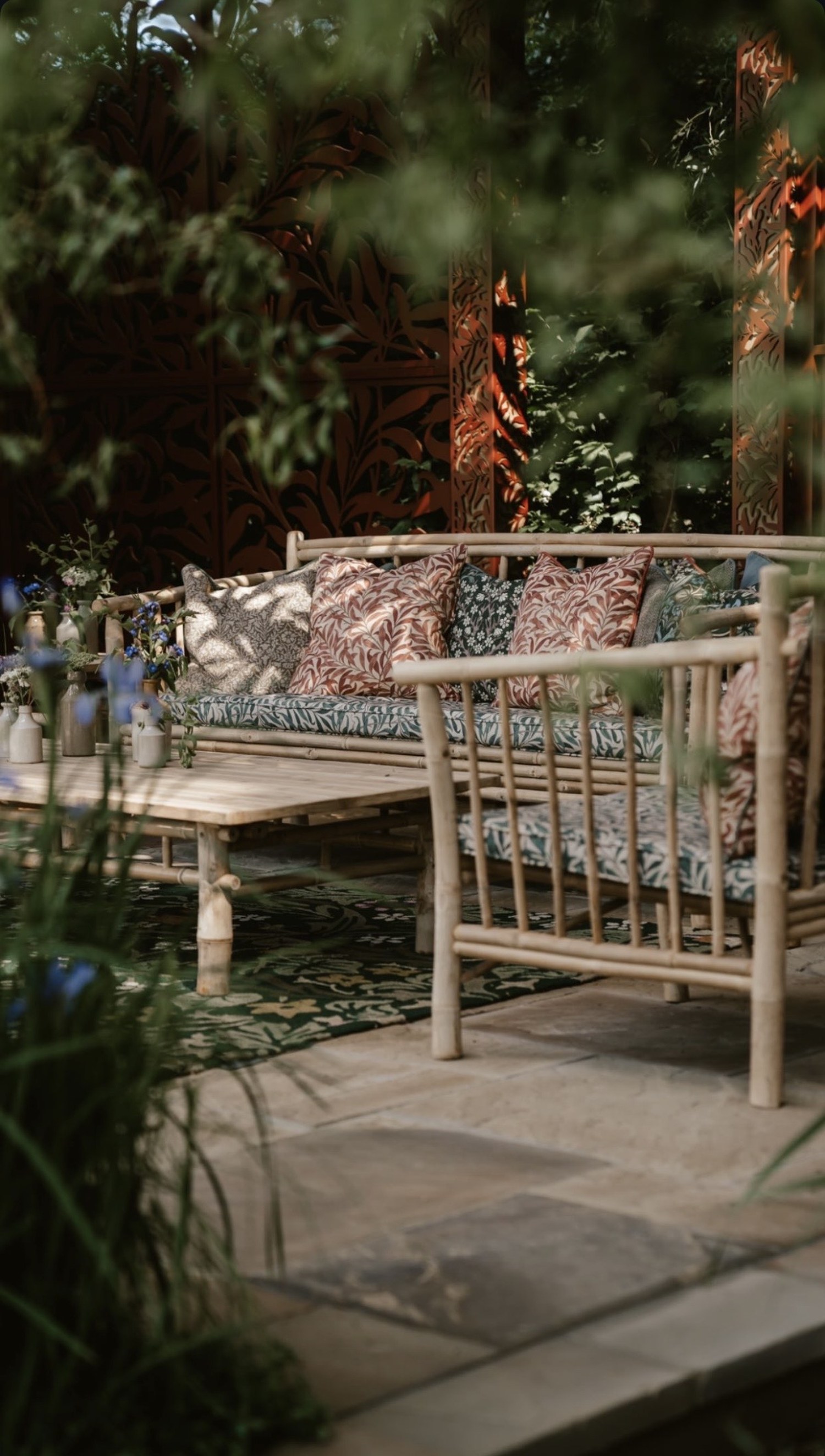 Table laid with teapot and cups beside a stone wall, RHS Chelsea Flower Show 2022, London