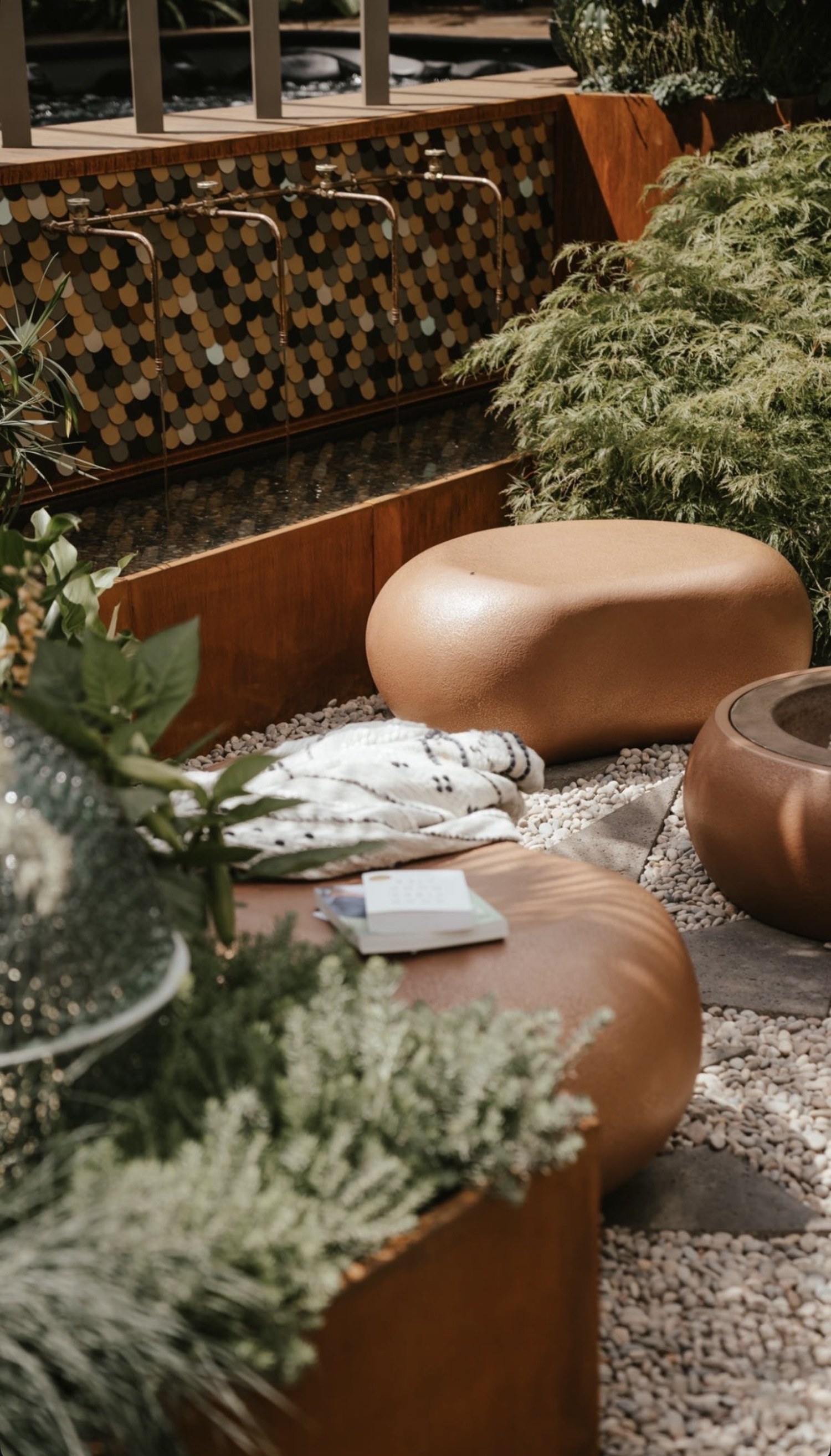 Scaled tile wall with copper tap and folded cloth, RHS Chelsea Flower Show 2022, London