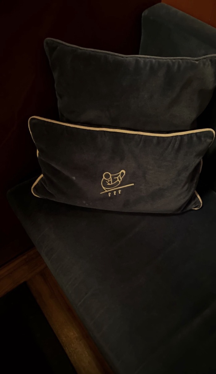 Dark velvet cushion with embroidered Cipriani gondolier logo and cream piping, Cipriani Dolci, Doha