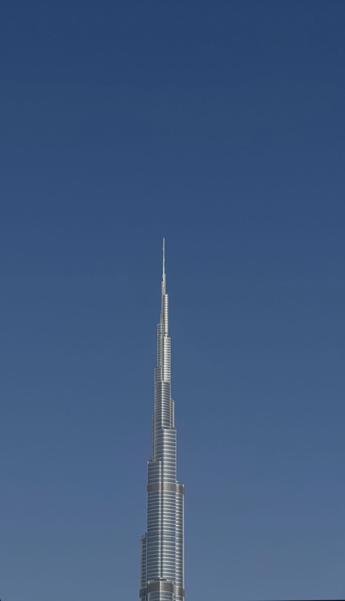 Burj Khalifa upper section against a clear blue sky, Dubai