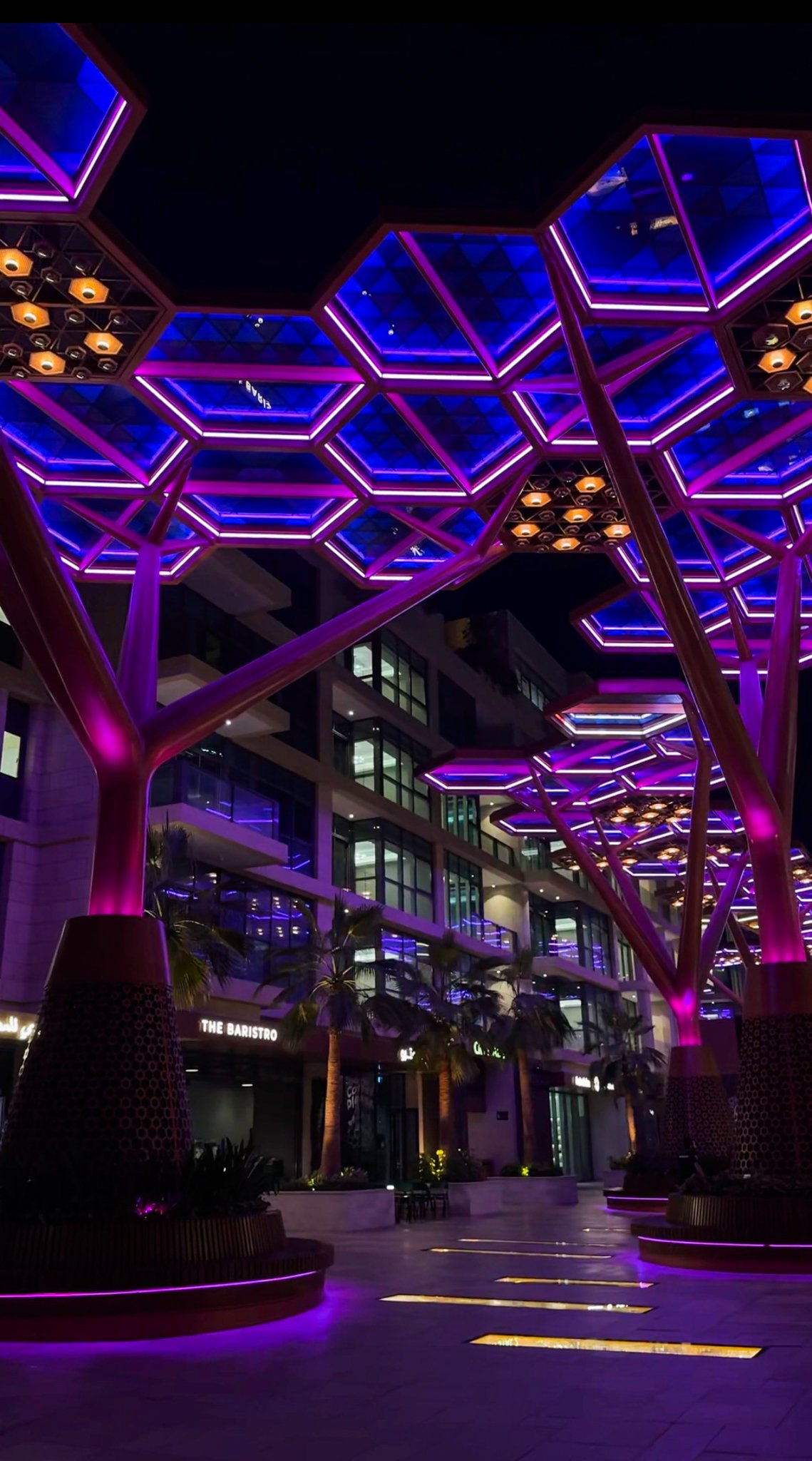 The promenade under violet canopies at night, Gewan Island, Doha