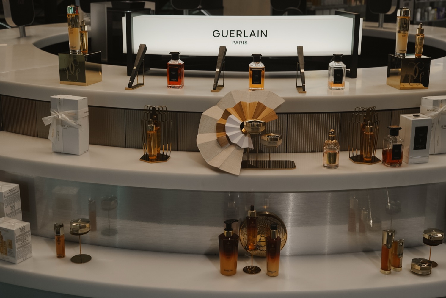 Curved Guerlain counter with fragrance display and fabric fan, Leeds