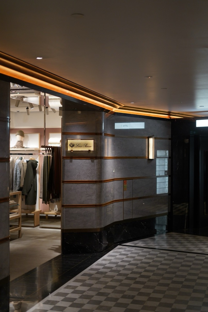 Loro Piana interior corridor with dark marble columns and warm ceiling light, Harrods, London