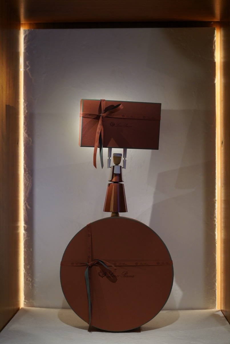 Loro Piana window niche with stacked gift boxes and sculptural figure, Harrods, London