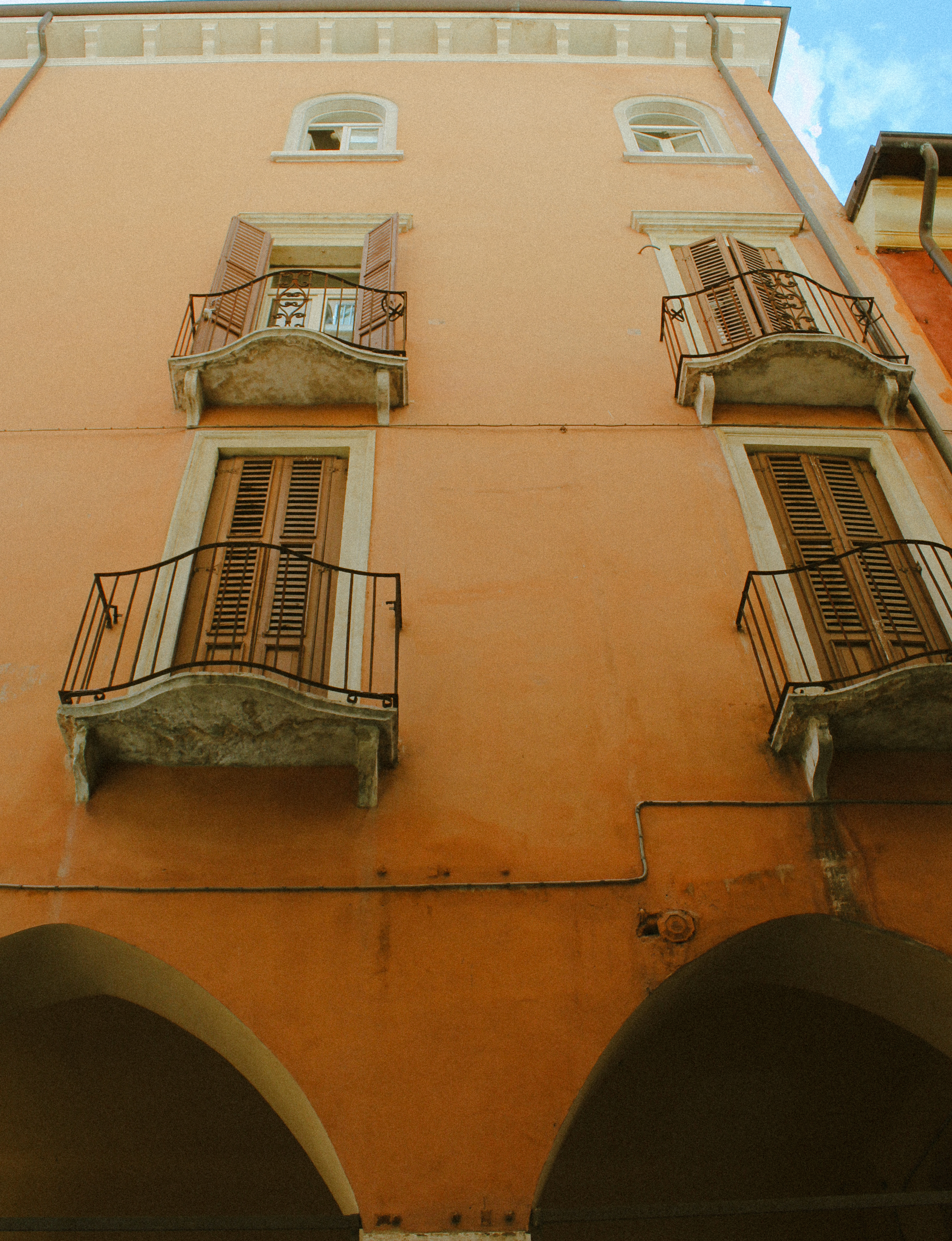 Orange facade and balconies, Italia