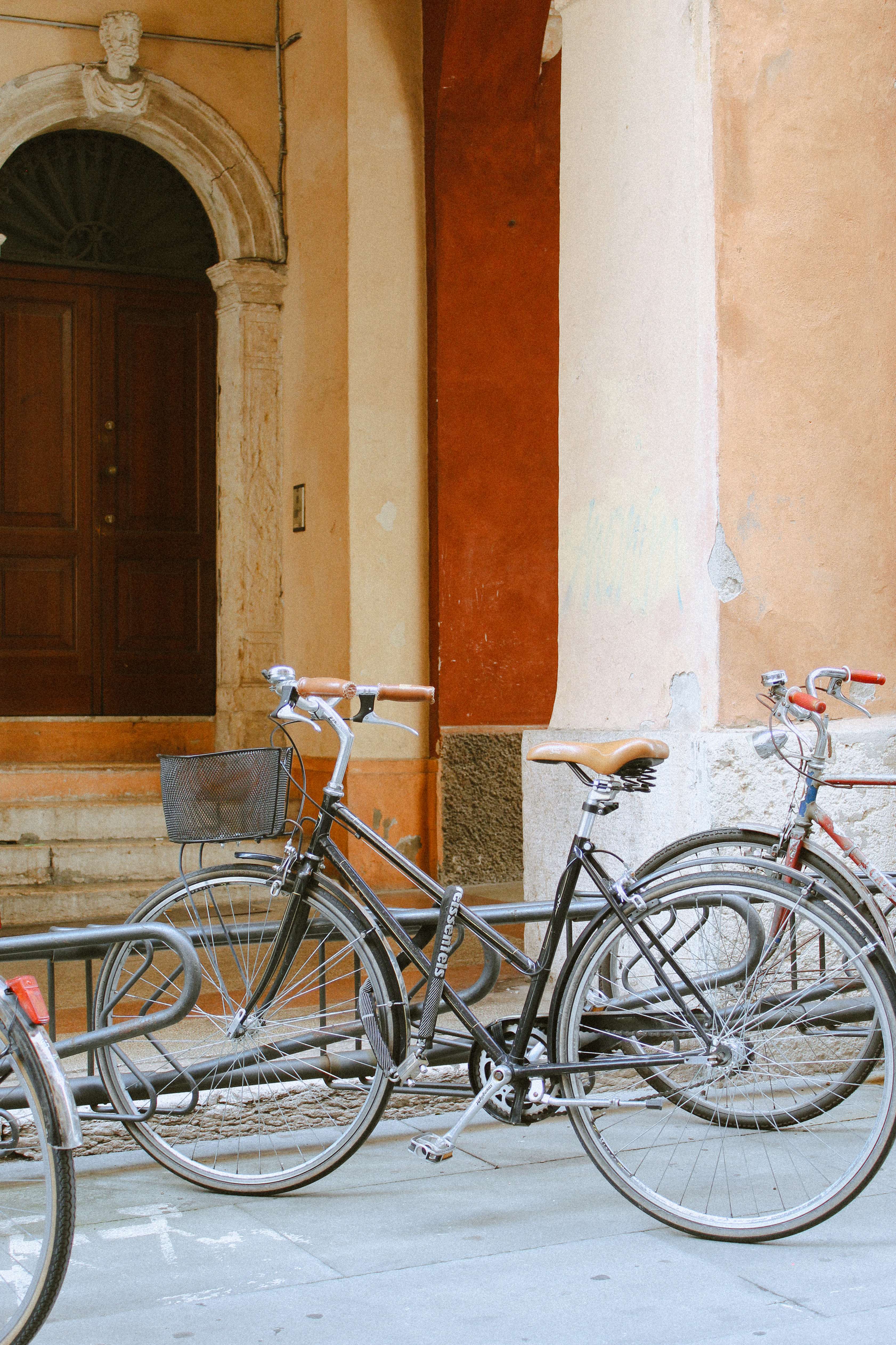 Bicycles against a terracotta wall, Italia