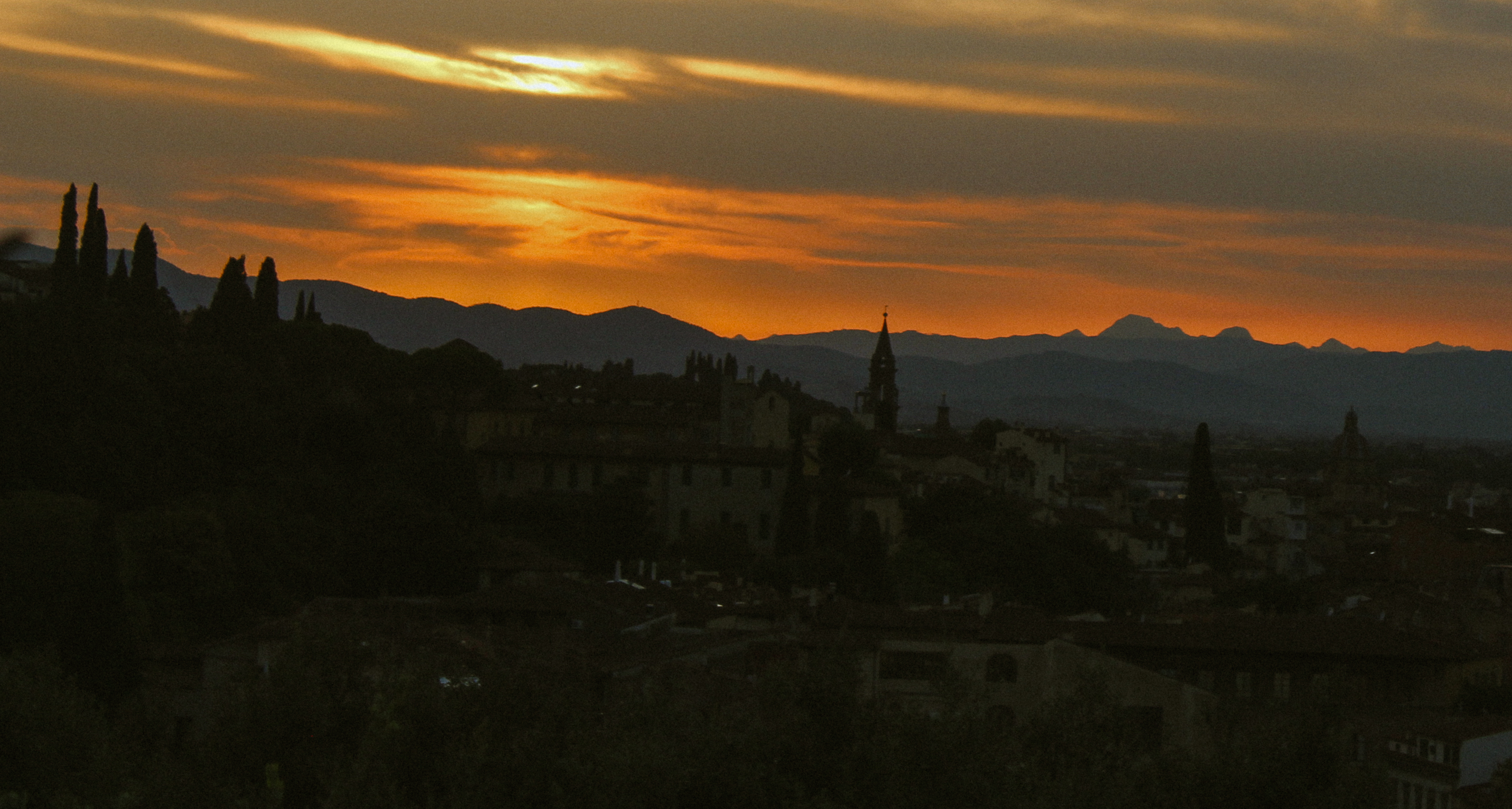 Florence at dusk, orange sky over the hills, Italia