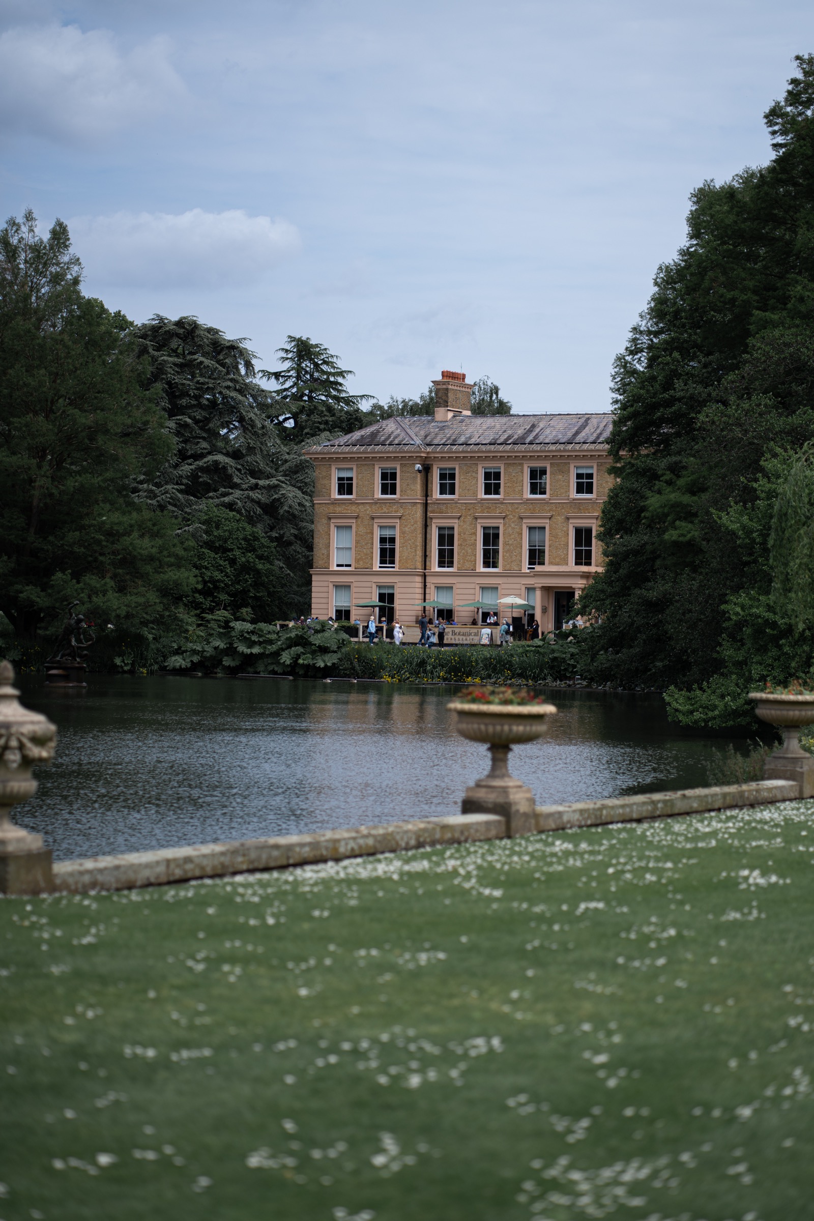 Figures moving through the courtyard, Royal Botanic Gardens, Kew