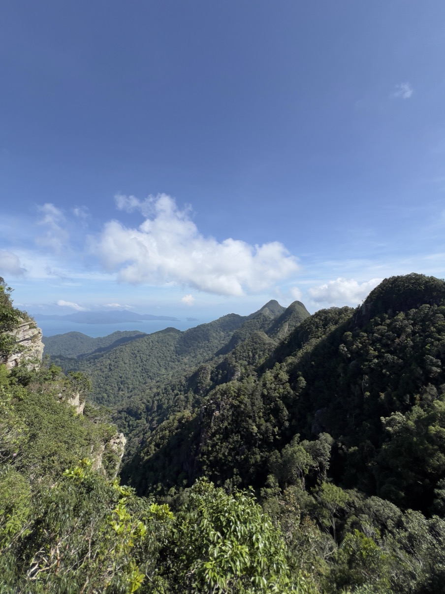 Rainforest mountain edge against clear blue sky, Langkawi