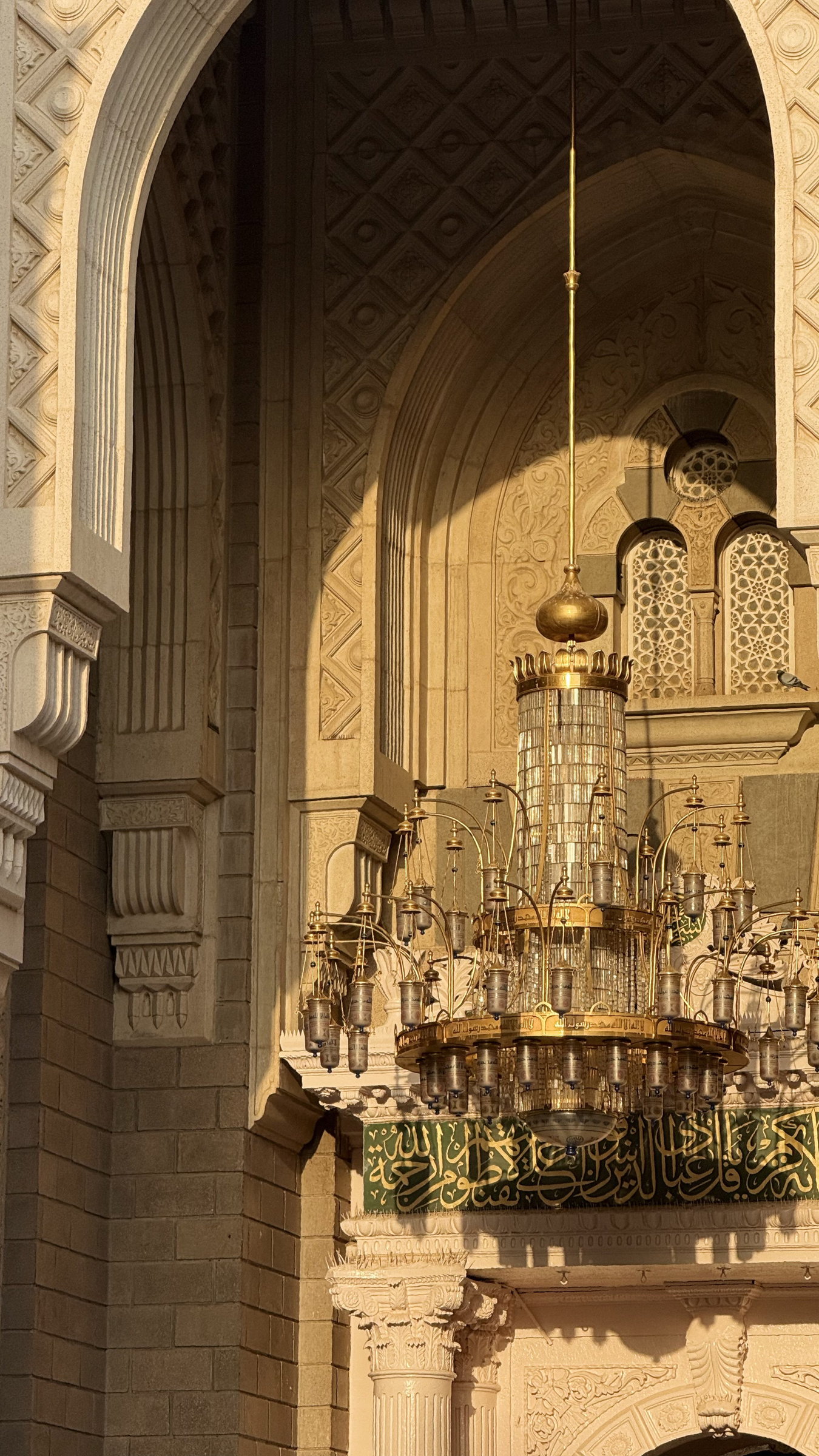 Chandelier in warm golden arch light, Al-Masjid an-Nabawi, Madinah al-Munawwarah