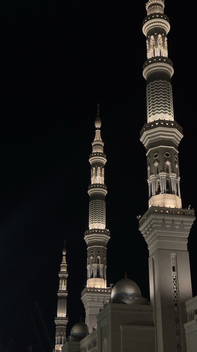 Three minarets of Al-Masjid an-Nabawi lit at night, Madinah al-Munawwarah