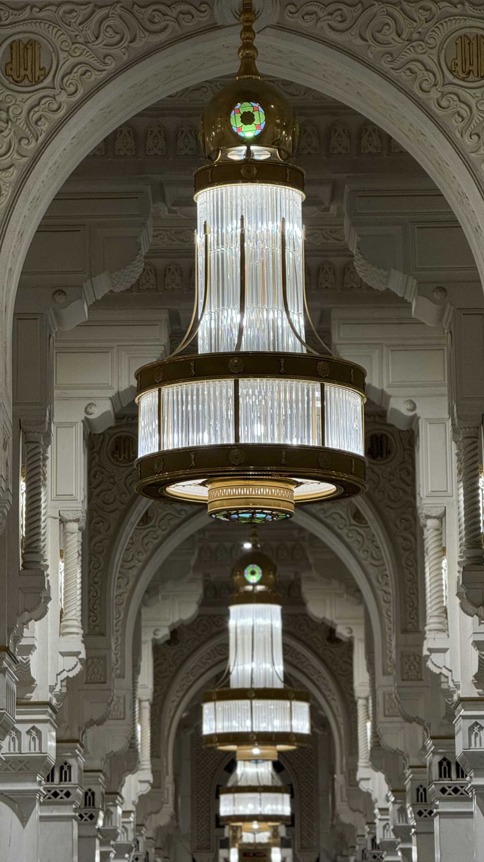Chandeliers inside the Grand Mosque corridor with arches, Makkah al-Mukarramah