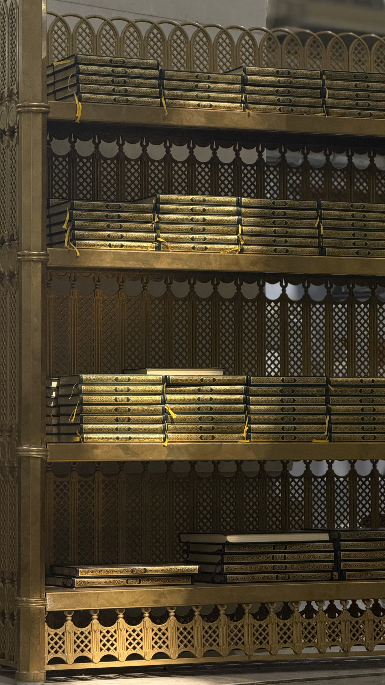 Qur'ans arranged on a brass shelf, Grand Mosque, Makkah al-Mukarramah