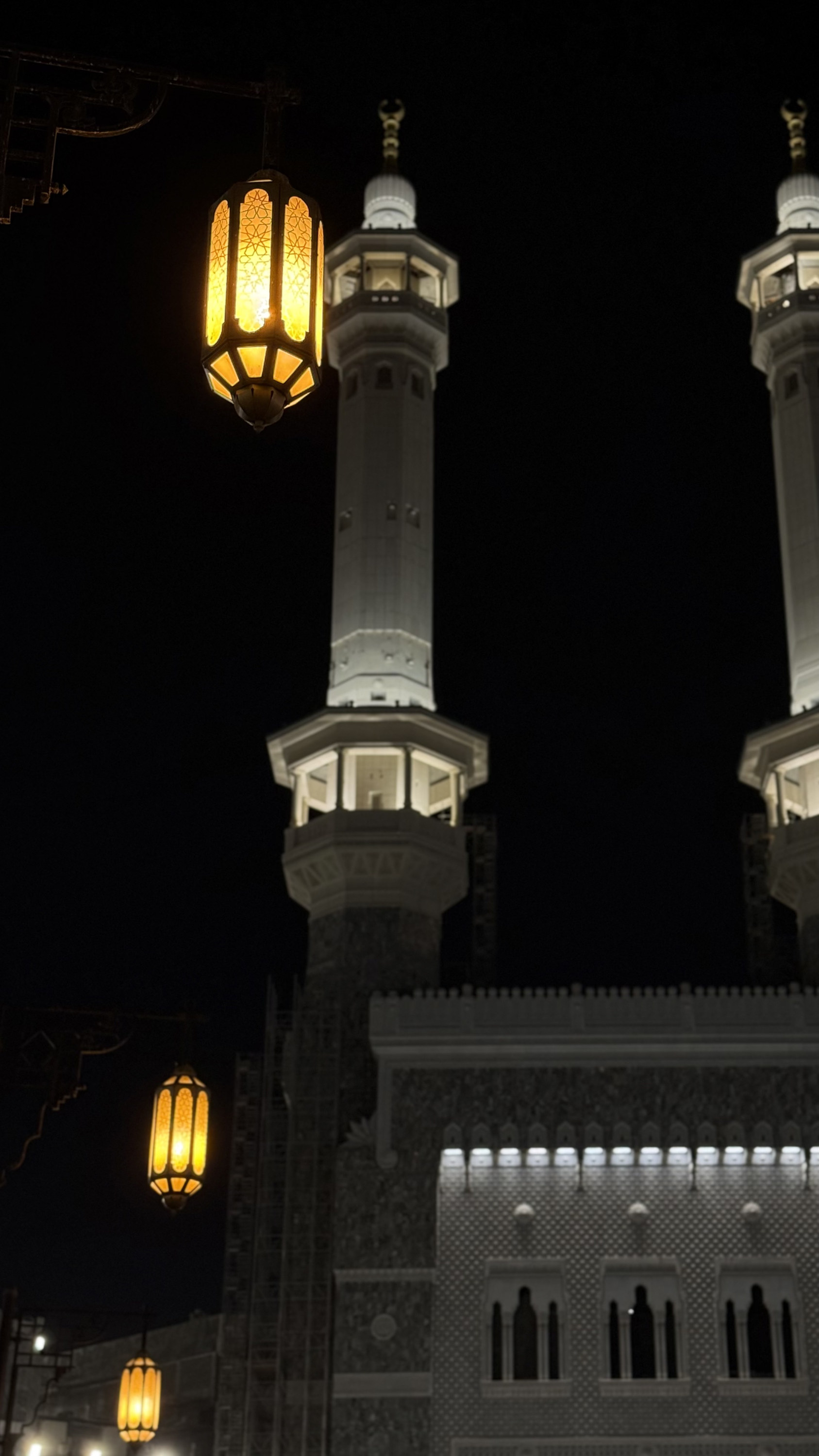 Minarets and hanging lanterns at night, Grand Mosque, Makkah al-Mukarramah