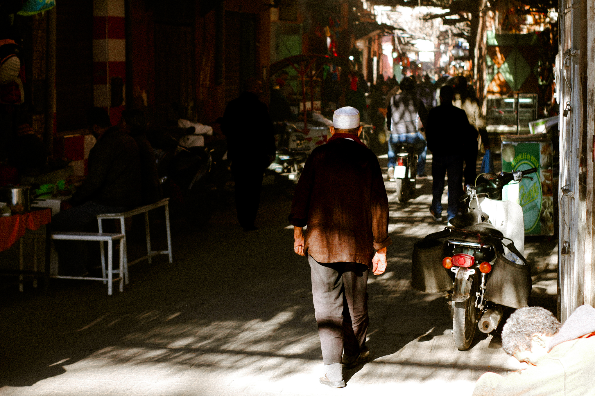 A man walking through the dappled light of the medina, Marrakech