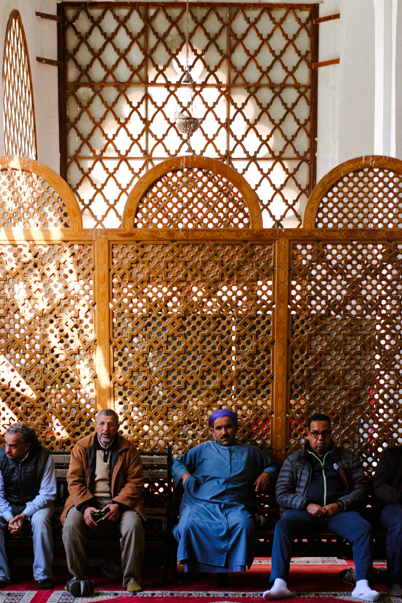 Men resting against a carved screen, Marrakech