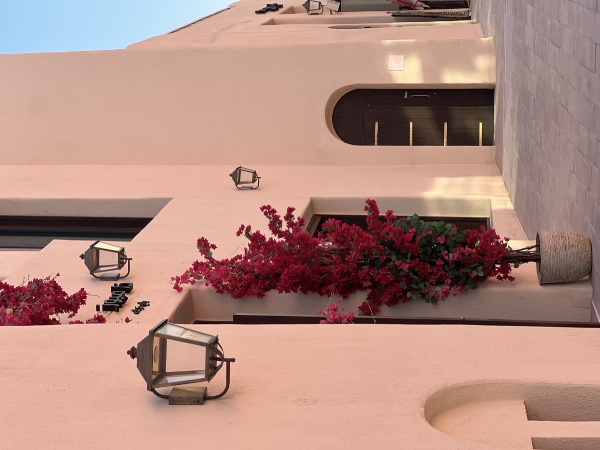 Pink wall with red bougainvillea and wall lamps, Mina District, Doha