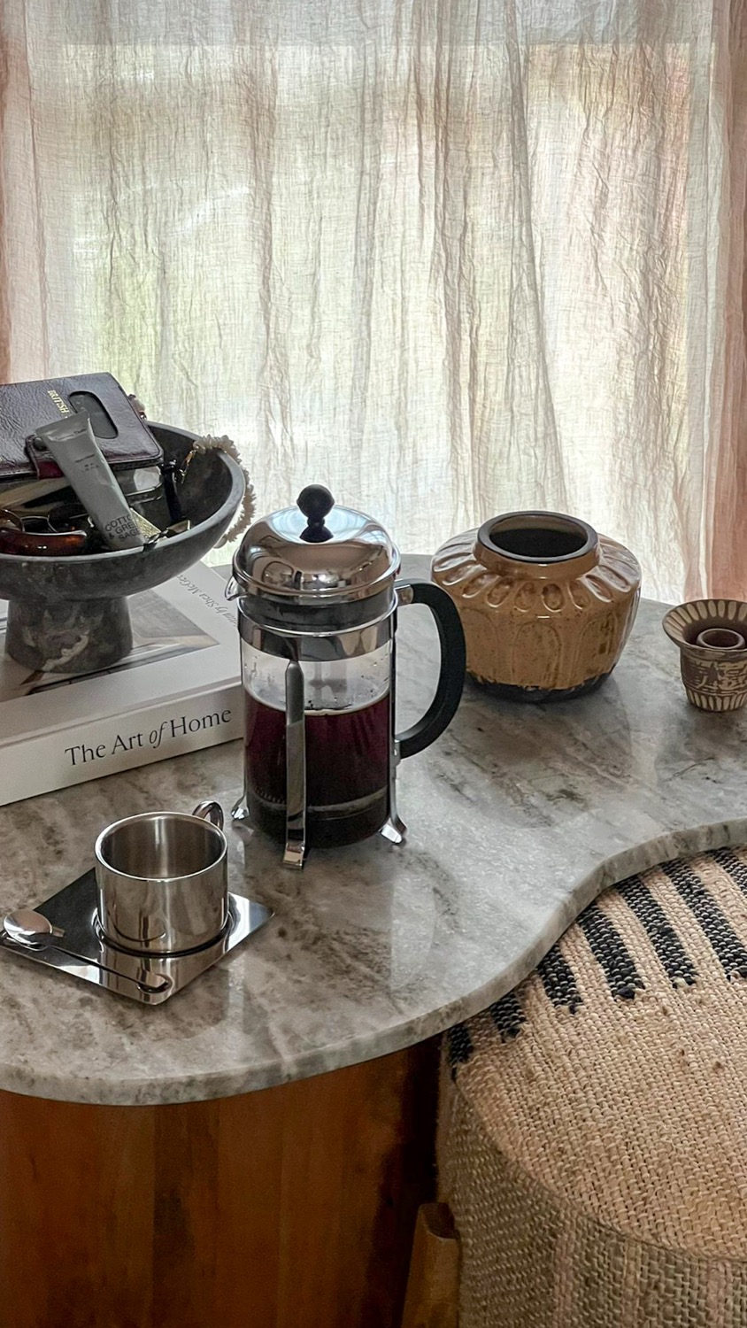 French press and cups on marble, morning ritual, home