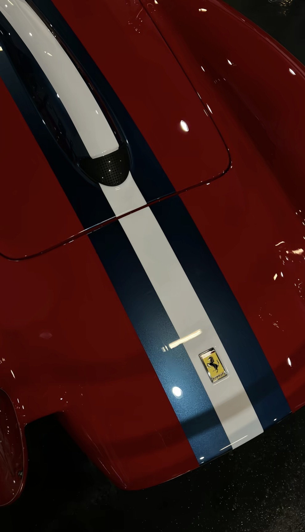 Ferrari bonnet with racing stripe, badge catching the light