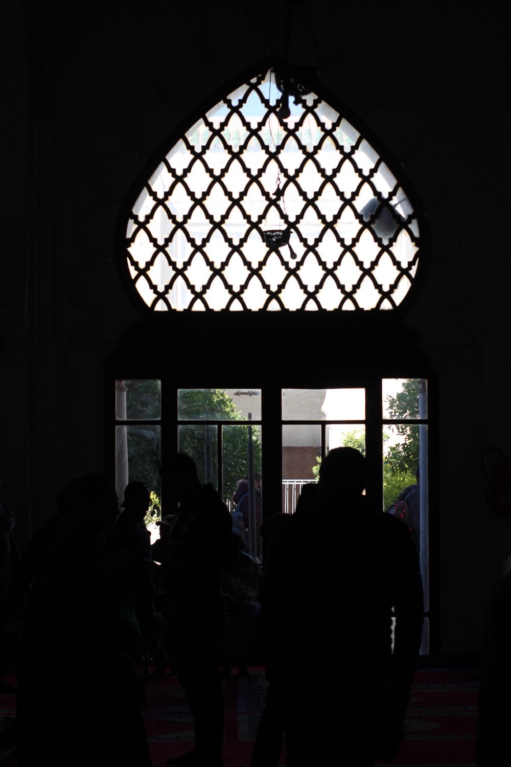 Silhouette at a mashrabiya lattice window