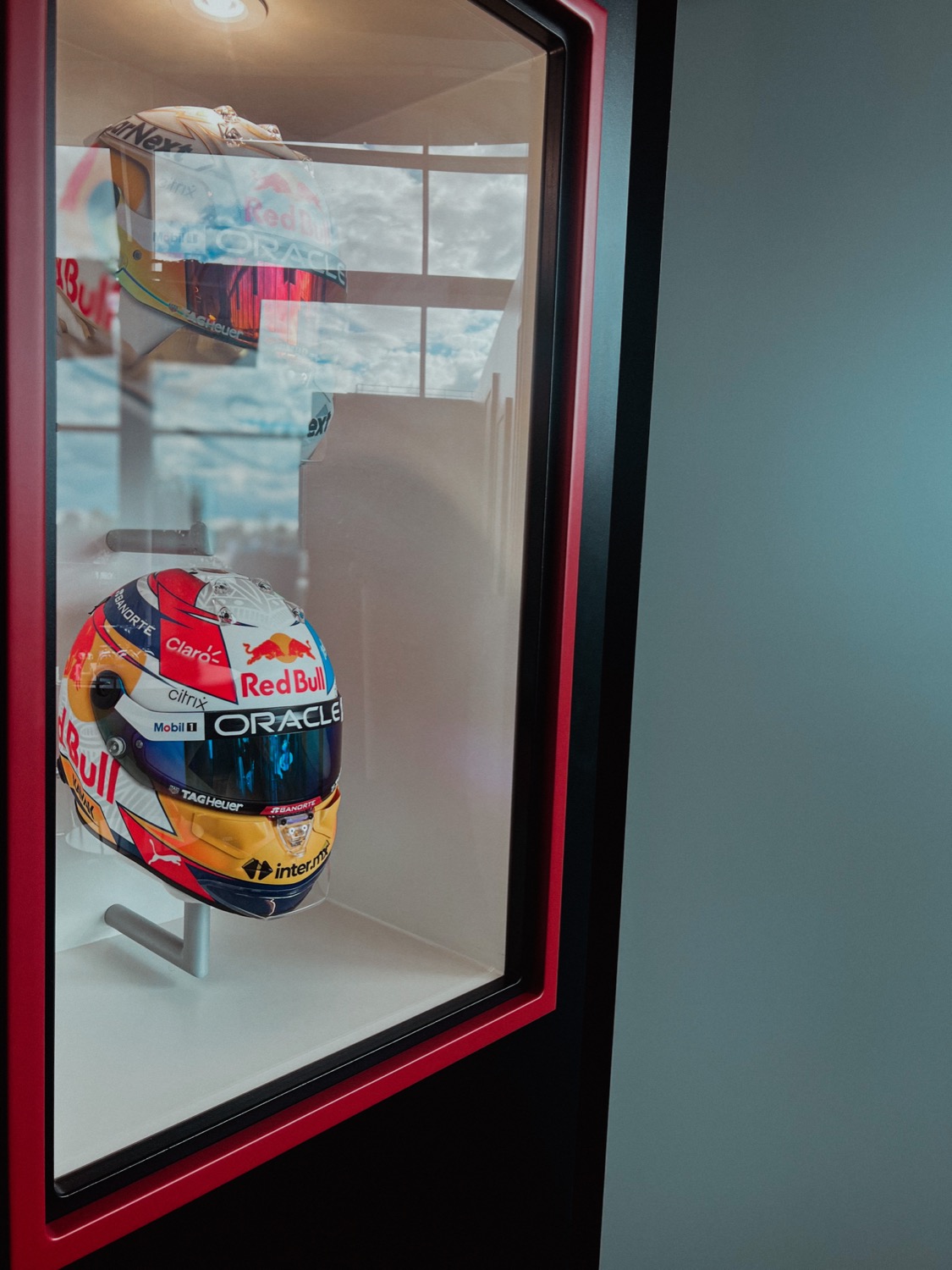 Red Bull F1 helmets in a display case