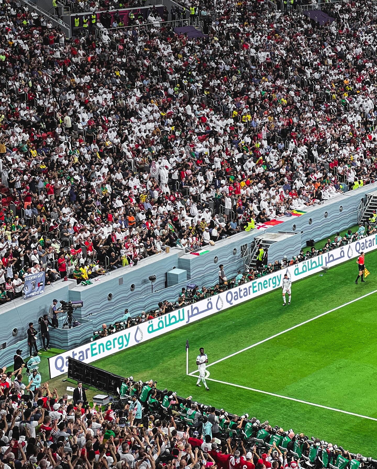 A corner flag and the massed crowd at the FIFA World Cup, Qatar 2022