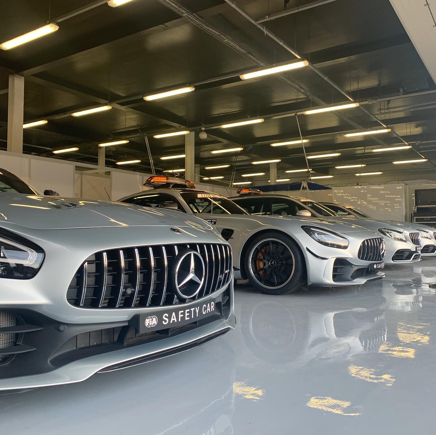 Mercedes AMG GT safety cars lined up in a garage