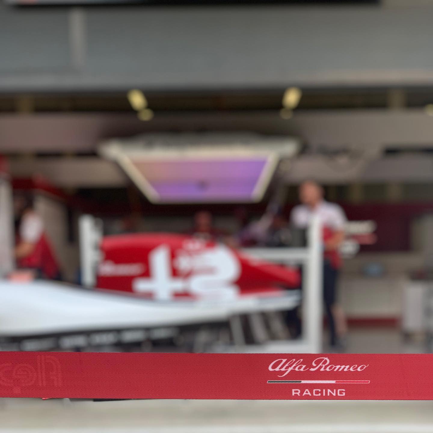 Alfa Romeo garage seen shallow through the pit lane, the car under its livery