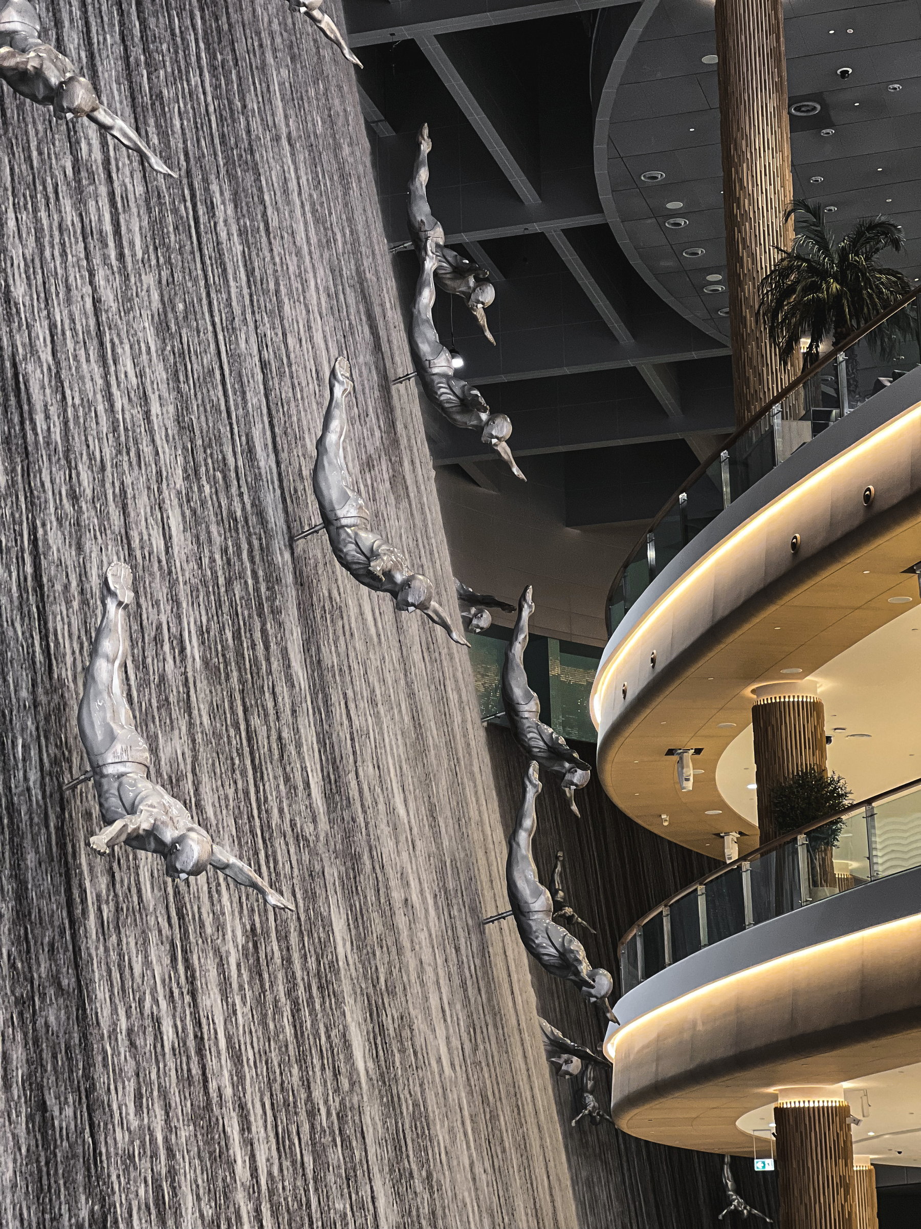 Sculpted divers descending the waterfall wall, Dubai Mall