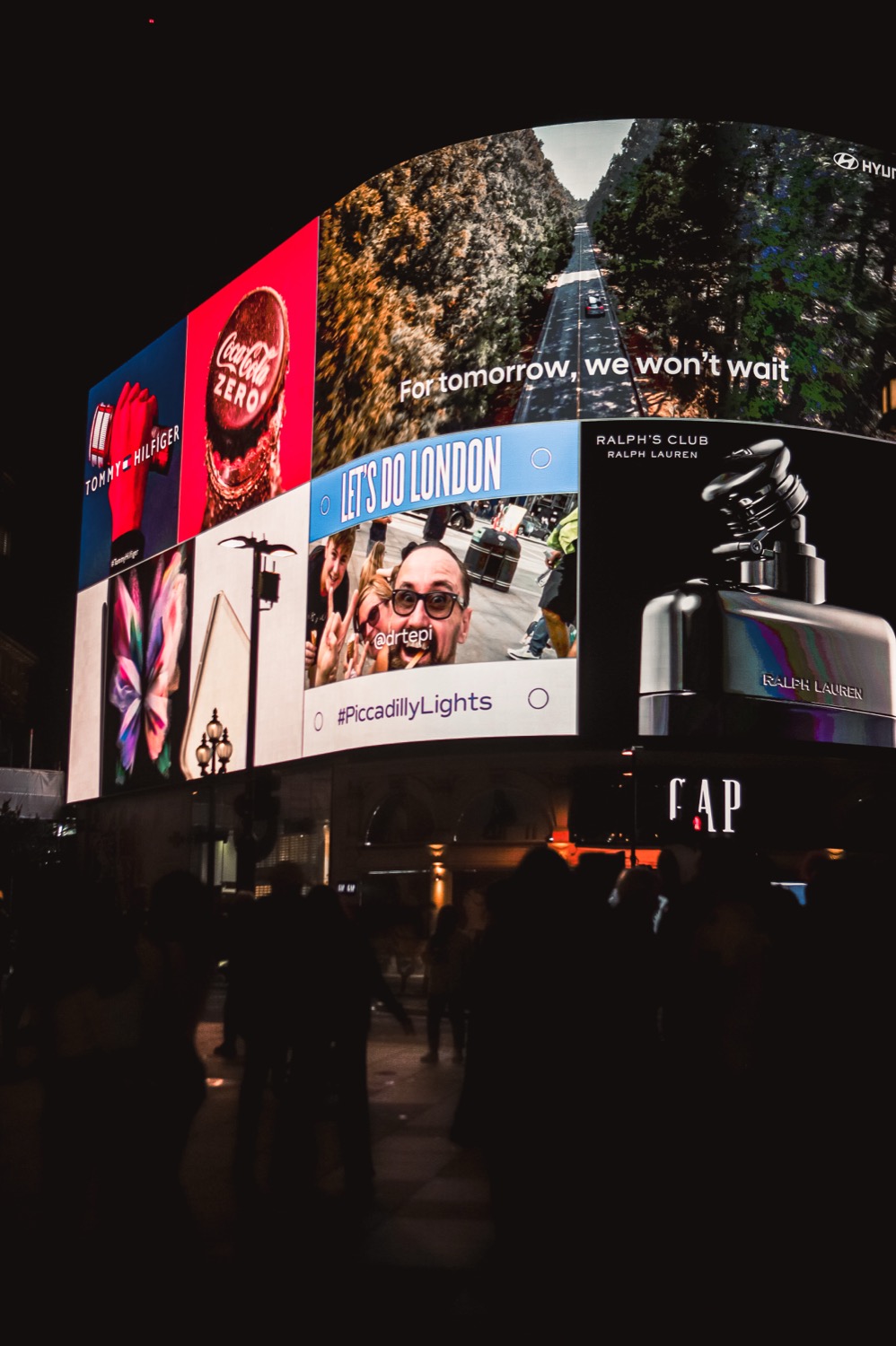 Piccadilly Circus at night, digital billboards lit against a dark sky, London