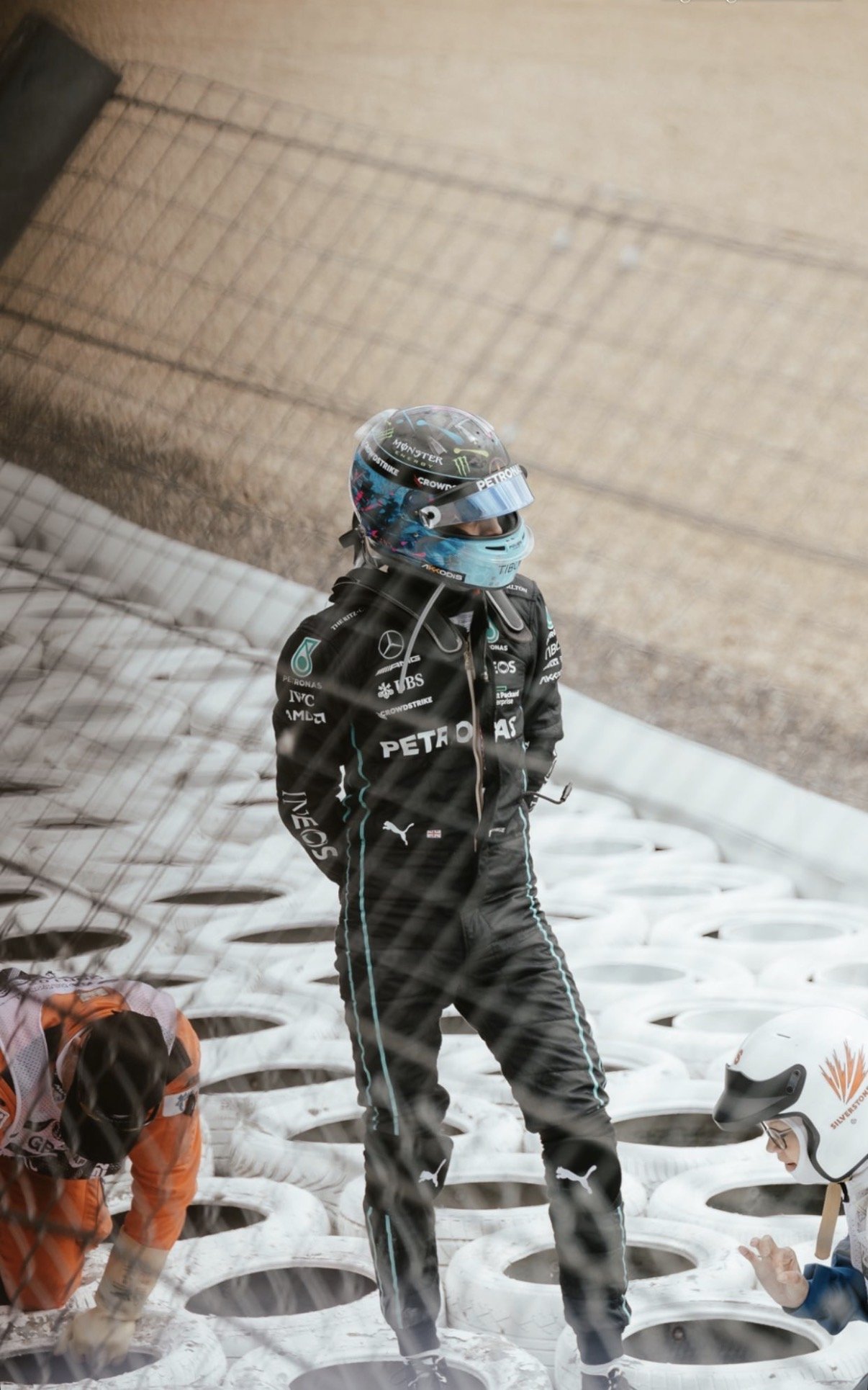 Marshal in the tyre barrier, Formula One paddock, Silverstone