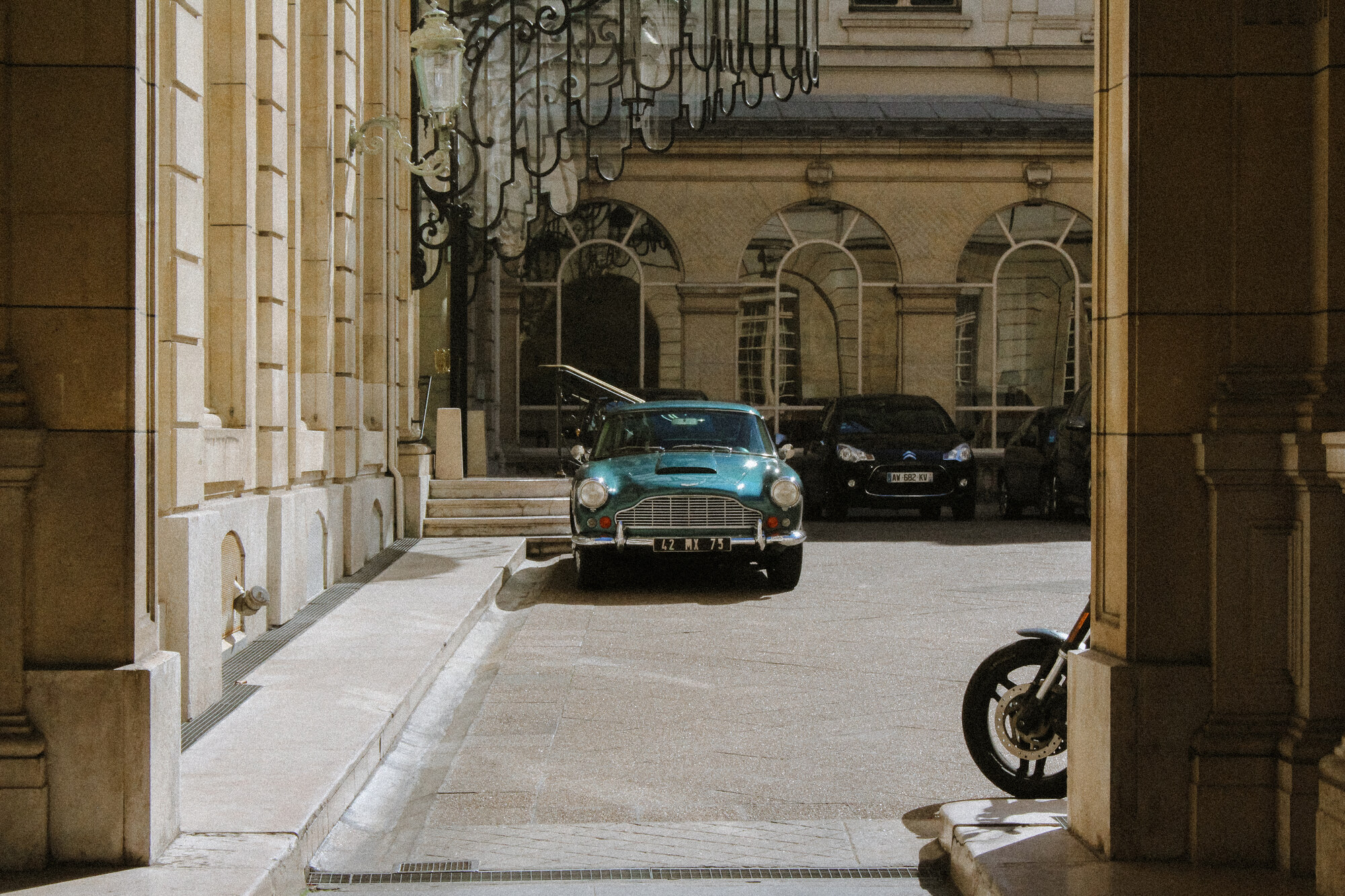 An Aston Martin in a palace courtyard, Paris, France