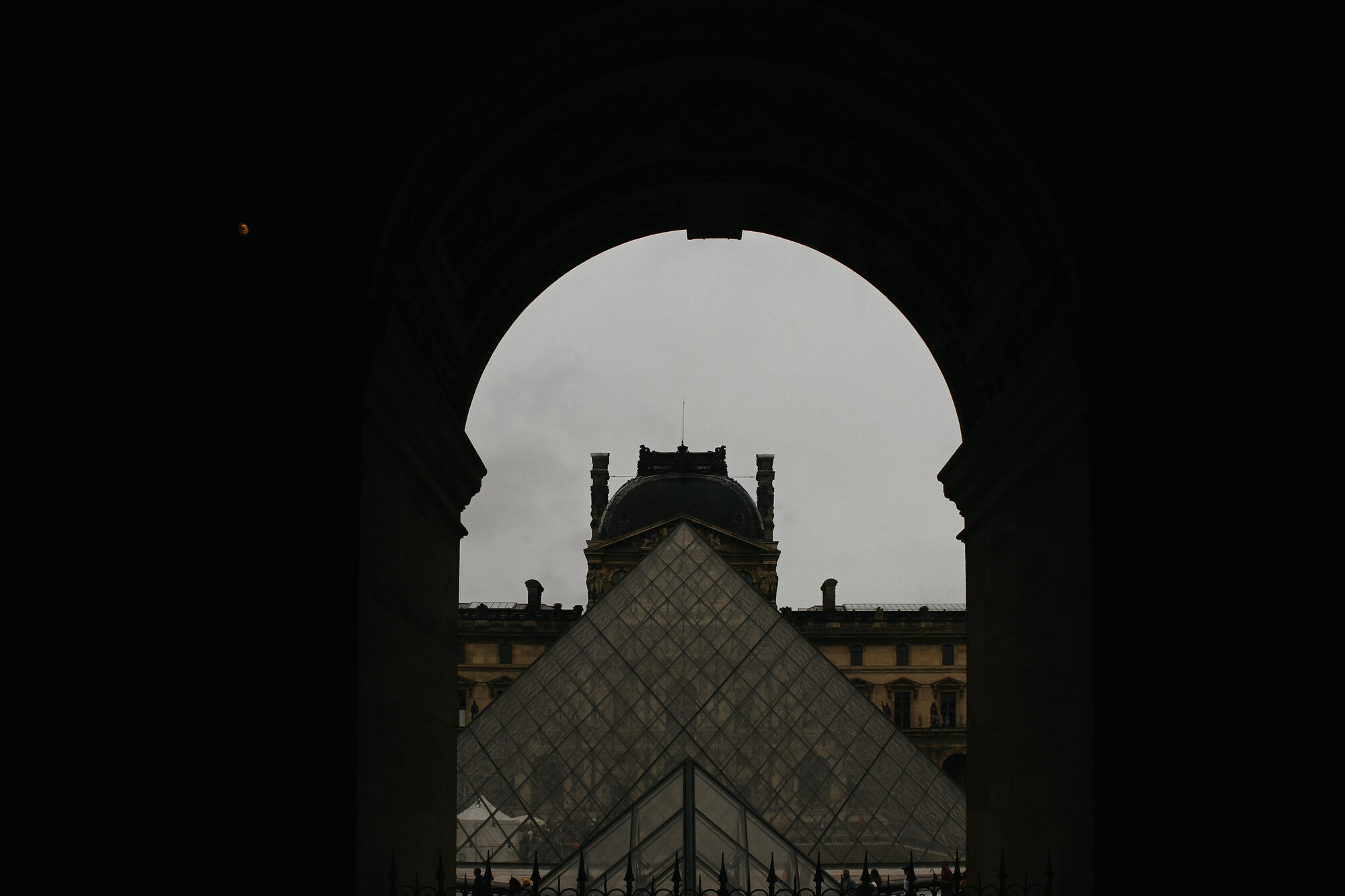 The pyramid framed through an archway, Louvre, Paris, France