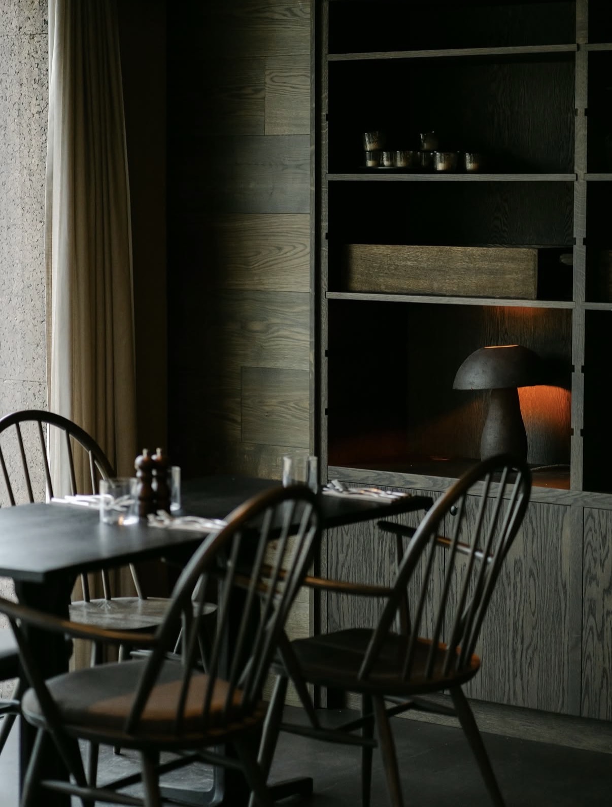 The Penny Bun dining room, Askwith. Windsor chairs, timber shelving, mushroom lamp.