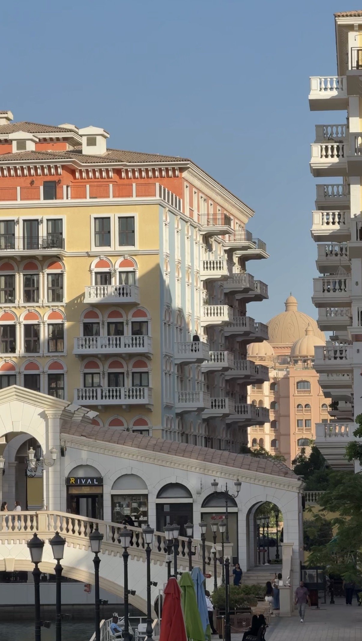 A footbridge and towers in the late light, Qanat Quartier, Doha
