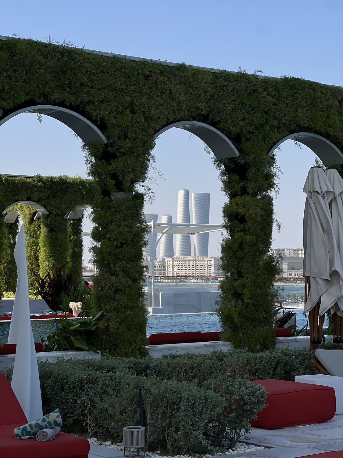 Green arches framing the Doha skyline, Raffles Doha hotel